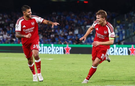 Martin Ødegaard (right) wheels away alongside Bruno Guimarães after scoring the winner