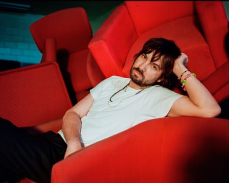 Kevin Parker on red couch
