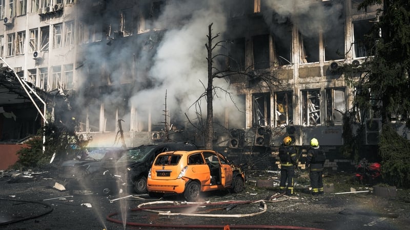 a yellow car is seen in a street damaged in Kyiv