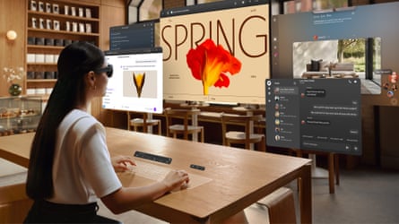 A woman works with multiple virtual windows in a cafe wearing the Meta VR Glasses.