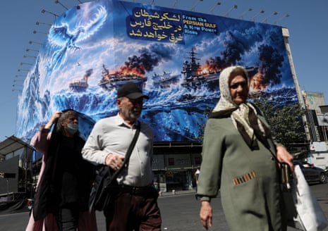 People walk past a billboard about the strait of Hormuz in Tehran, Iran