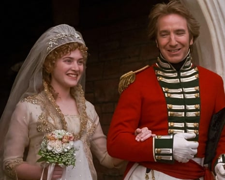 Kate Winslet as a bride smiles beside Alan Rickman in a red military uniform